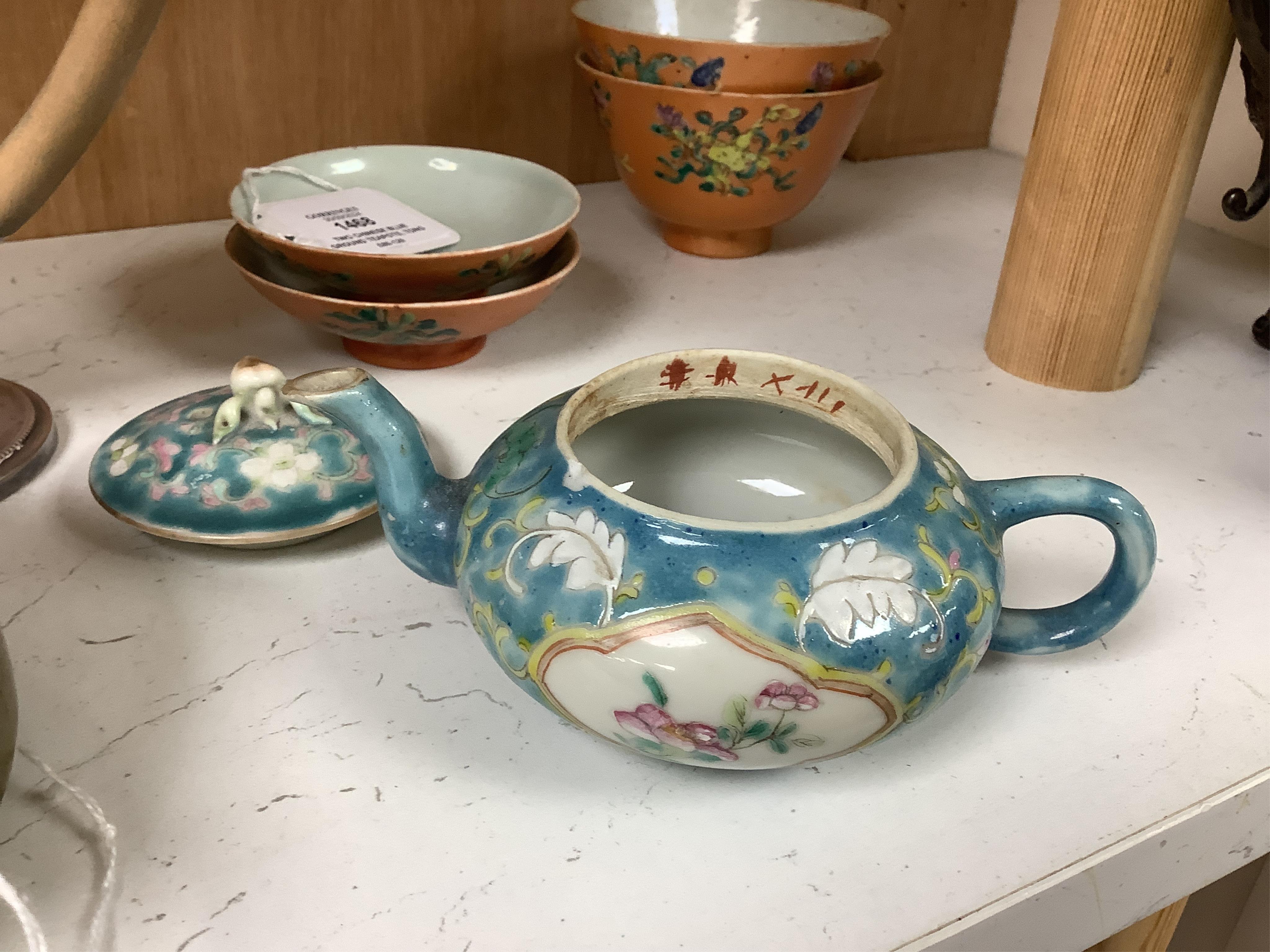 Two Chinese blue ground teapots, Tongzhi mark, and a pair of orange ground bowls and covers, teapots 15cm wide. Condition - fair